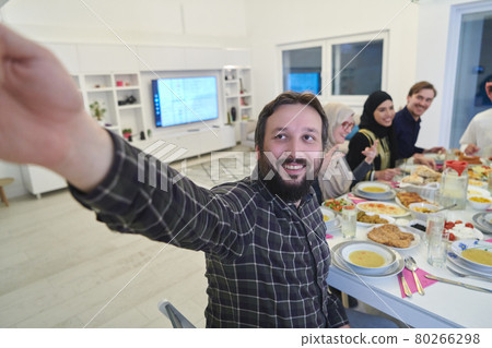 Muslim family taking selfie while having iftar together during Ramadan Muslim family taking selfie while having iftar together during Ramadan 80266298