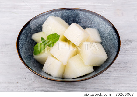 slices of fresh juicy melon, served with mint 80266868