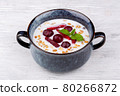 rice porridge with berries, served with mint 80266872