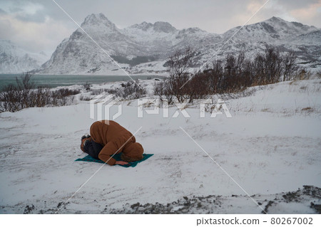 Muslim traveler praying in cold snowy winter day Muslim traveler praying in cold snowy winter day 80267002