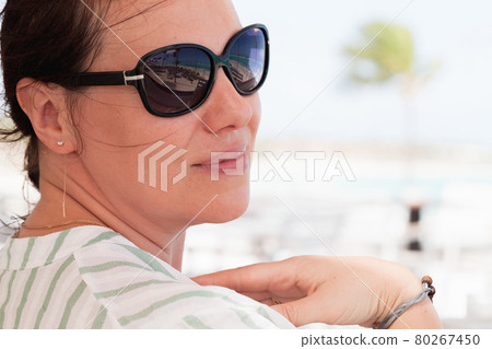Happy young Caucasian woman in sunglasses Happy young Caucasian woman in sunglasses 80267450