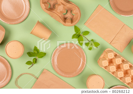 Flat lay composition with eco-friendly tableware and kraft paper food packaging on green background. Sustainable packaging, recyclable paperware, zero waste packaging concept. Selective focus, mockup Flat lay composition with eco-friendly tableware and kraft paper food packaging on green background. Sustainable packaging, recyclable paperware, zero waste packaging concept. Selective focus, mockup 80268212