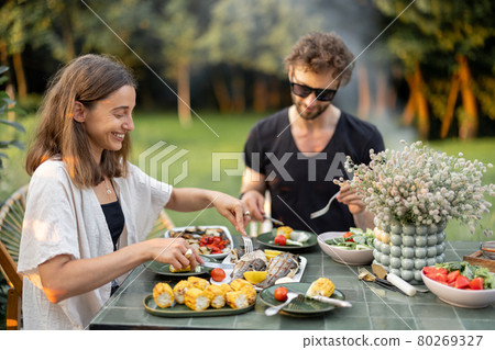 Couple having lunch with healthy food outdoors Couple having lunch with healthy food outdoors 80269327