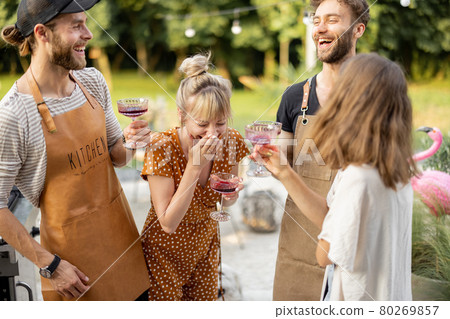 Friends celebrating with alcohol drinks outdoors Friends celebrating with alcohol drinks outdoors 80269857