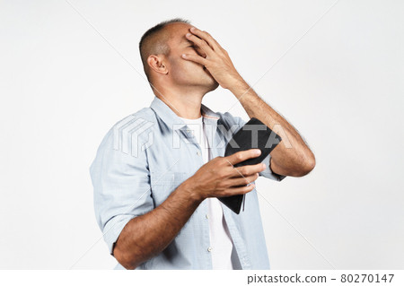 Upset mature man holding his empty wallet on white background. financial crisis, bankruptcy, no money, bad economy Concept. 80270147