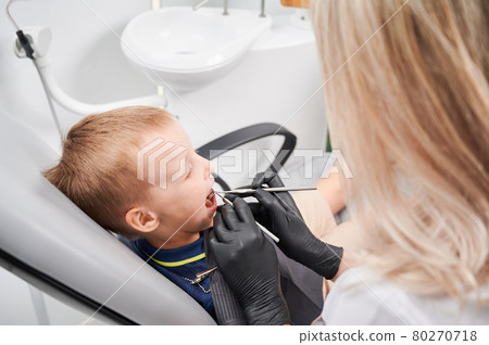 Little boy in dentist's chair during examination process Little boy in dentist's chair during examination process 80270718