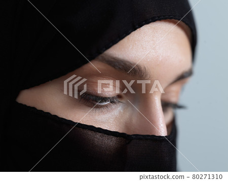 Portrait of muslim woman wearing niqab and traditional arabic clothes or abaya Portrait of muslim woman wearing niqab and traditional arabic clothes or abaya 80271310