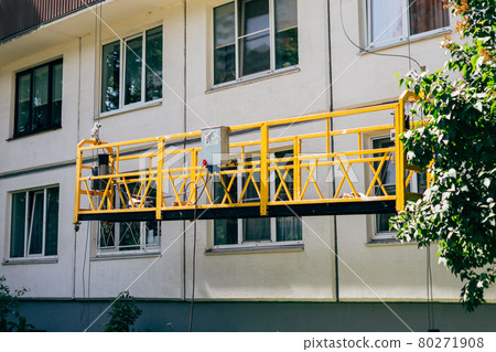 Suspended construction cradle. Facing, repair, maintenance, painting the building. Suspended construction cradle. Facing, repair, maintenance, painting the building. 80271908