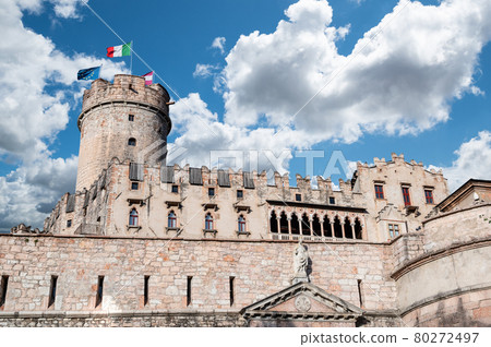 Trento, Italy, June 2021. The imposing Buonconsiglio castle, detail of the tower surmounted by the Euroopean, Italian, and regional flags. Beautiful summer day. Trento, Italy, June 2021. The imposing Buonconsiglio castle, detail of the tower surmounted by the Euroopean, Italian, and regional flags. Beautiful summer day. 80272497