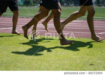 Runner running barefoot on the grass Runner running barefoot on the grass 80272804