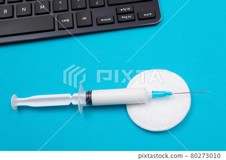 Vaccination or Revaccination Concept - A Medical Syringe on Blue Table 80273010