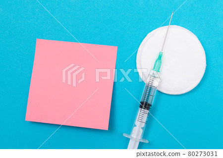 Vaccination or Revaccination Concept - A Medical Syringe on Blue Table 80273031