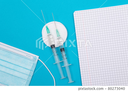 Vaccination or Revaccination Concept - Three Insulin Syringe on Blue Table 80273040