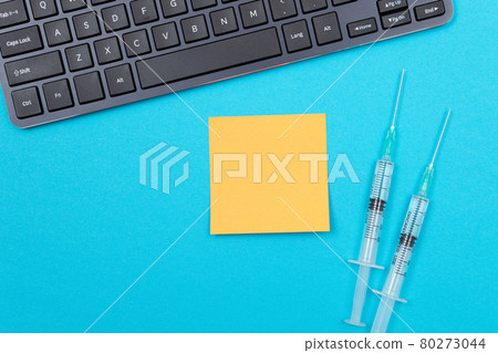 Vaccination or Revaccination Concept - Two Medical Syringe on Blue Table 80273044