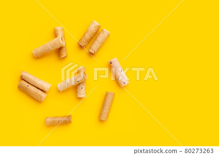 Thai crispy coconut rolls on yellow background. Thai crispy coconut rolls on yellow background. 80273263