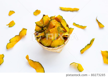 Green pumpkin slice chips on white background. Green pumpkin slice chips on white background. 80273285