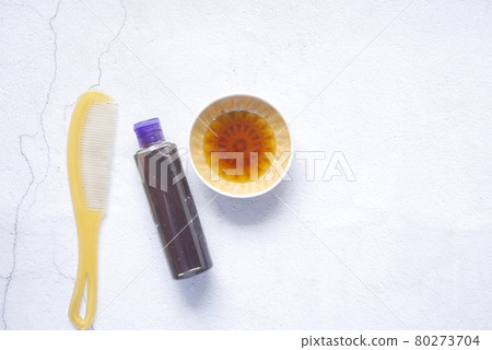 hair oil, comb and container on table , top view , 80273704
