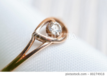 Gold wedding ring with ribbon macro. 80274918