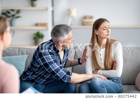 Mature married man supporting his depressed wife on consultation with psychologist at office. Family therapy concept 80275442