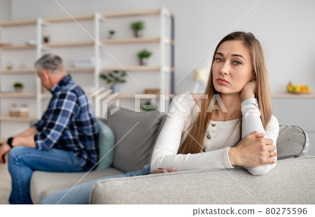 Mature couple sitting on couch after quarrel, feeling offended, not talking to each other, having relationship problems Mature couple sitting on couch after quarrel, feeling offended, not talking to each other, having relationship problems 80275596