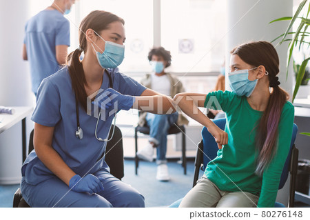 Teen Girl In Medical Mask Bumping Elbows Meeting Female Doctor 80276148