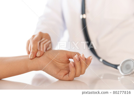 Close-up hands of doctor, therapeutic or medical advisor measuring pulse to patient, sick. Concept of healthcare, care and medicine. Close-up hands of doctor, therapeutic or medical advisor measuring pulse to patient, sick. Concept of healthcare, care and medicine. 80277816
