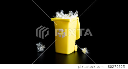 Trash plastic recycle. Bin container for disposal garbage waste and save environment. Yellow dustbin for recycle plastic trash isolated on black background. 80279625