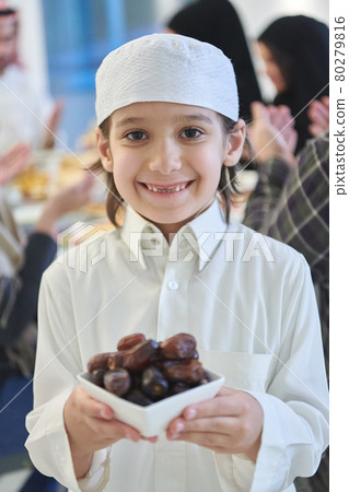 Arabian kid in the traditional clothes during iftar 80279816
