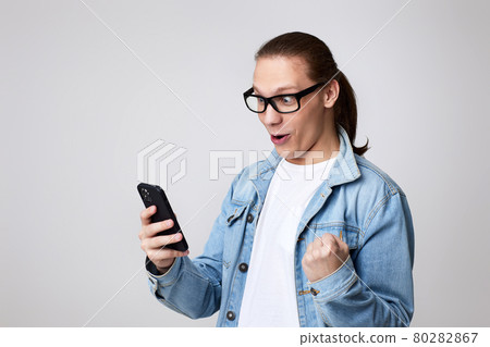 young man in glasses using smart phone 80282867