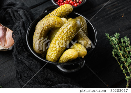 Pickled homemade cucumbers, pickles, on black wooden table background Pickled homemade cucumbers, pickles, on black wooden table background 80283017