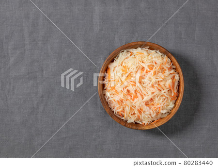 Homemade sauerkraut. Fermented food. Sauerkraut with carrots in a bowl on a gray background. Homemade sauerkraut. Fermented food. Sauerkraut with carrots in a bowl on a gray background. 80283440