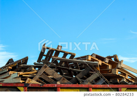 Old scrapped wooden shipping pallets in a randomly pile. Dumpster. Garbage removal Old scrapped wooden shipping pallets in a randomly pile. Dumpster. Garbage removal 80284233