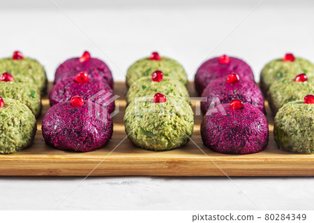 Pkhali with beets and beans on a cutting board on a white background. Traditional Georgian dish of vegetables, walnuts and spices 80284349