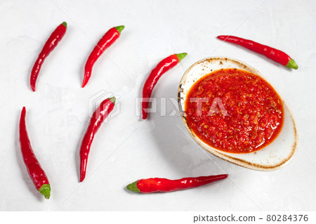 Hot chili pepper sauce paste harissa. Adjika. Traditional Tunisia, Georgian and Arabic cuisine. Homemade rose harissa in a bowl. Hot chili pepper sauce paste harissa. Adjika. Traditional Tunisia, Georgian and Arabic cuisine. Homemade rose harissa in a bowl. 80284376