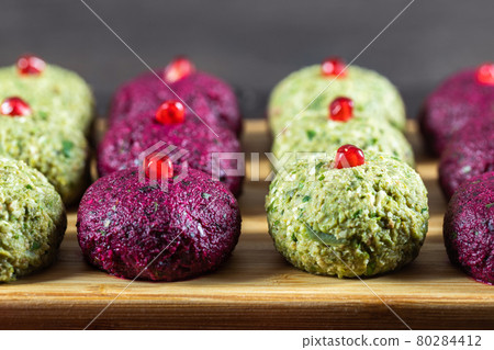 Pkhali with beets and beans on a chopping board closeup. Traditional Georgian dish of vegetables, walnuts and spices 80284412