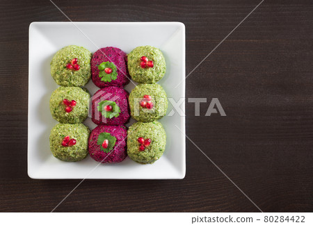 Pkhali with beets and beans on a dark wooden background. Traditional Georgian dish of vegetables, walnuts and spices. Copy space. Flat lay, top view 80284422