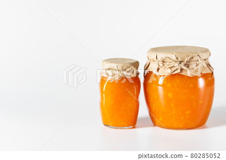 Delicious homemade jam in glass jars on a white background. Delicious homemade jam in glass jars on a white background. 80285052