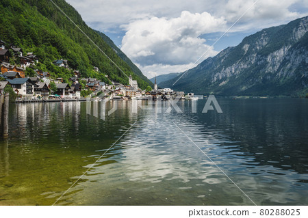 Scenic view of famous Hallstatt lakeside town reflecting in Hallstattersee lake in the Austrian Alps. Salzkammergut region, Austria Scenic view of famous Hallstatt lakeside town reflecting in Hallstattersee lake in the Austrian Alps. Salzkammergut region, Austria 80288025