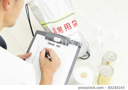 A man checking disaster prevention supplies 80288165