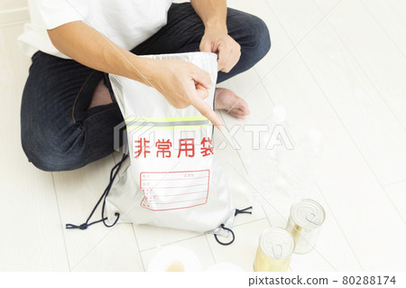 Men preparing disaster prevention supplies Men preparing disaster prevention supplies 80288174