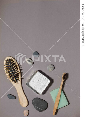 Eco-friendly products for skin and teeth care. Natural washcloth, bamboo toothbrush, tooth powder and soap with herbal extracts. Flatlay on a gray background, vertical Eco-friendly products for skin and teeth care. Natural washcloth, bamboo toothbrush, tooth powder and soap with herbal extracts. Flatlay on a gray background, vertical 80290634