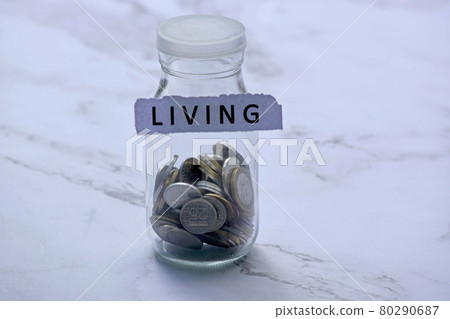 Blurred background of glass jar with multicurrency coins and text on white torn paper Blurred background of glass jar with multicurrency coins and text on white torn paper 80290687