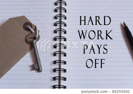 Text written on notebook with house key. Hard work concept Text written on notebook with house key. Hard work concept 80291692