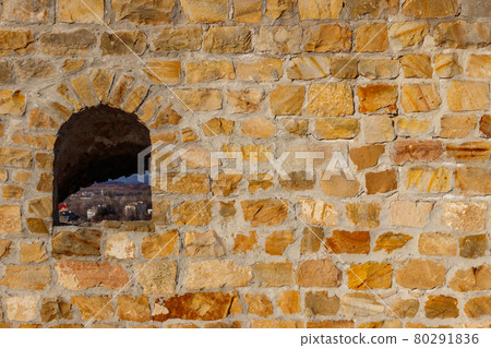 Background of the old stone wall with a loophole 80291836