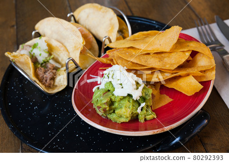 Mexican tacos with guacamole and nachos Mexican tacos with guacamole and nachos 80292393