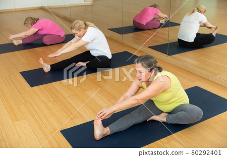 Group of active senior women practicing yoga Group of active senior women practicing yoga 80292401