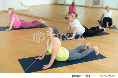 Women are doing upward-facing dog pose 80292628