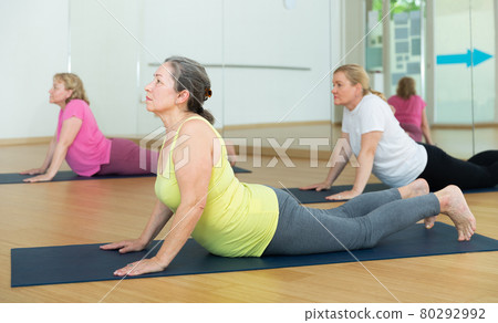 Women are doing upward-facing dog pose 80292992