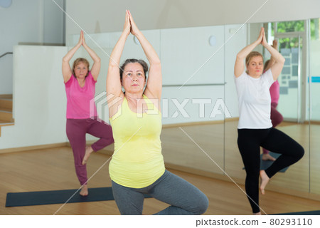 Active senior woman practicing balancing yoga pose Active senior woman practicing balancing yoga pose 80293110
