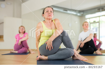 Aged women are doing lord of the fishes pose Aged women are doing lord of the fishes pose 80293167